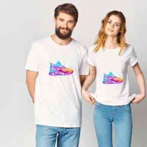 Man and woman modeling the matching QGM 'Journey of 1000 Miles' white unisex graphic tee with a vibrant, colorful running shoe design.